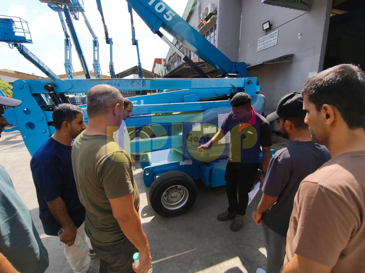 Instructor from MEWP supplier explains boom lift safety features.